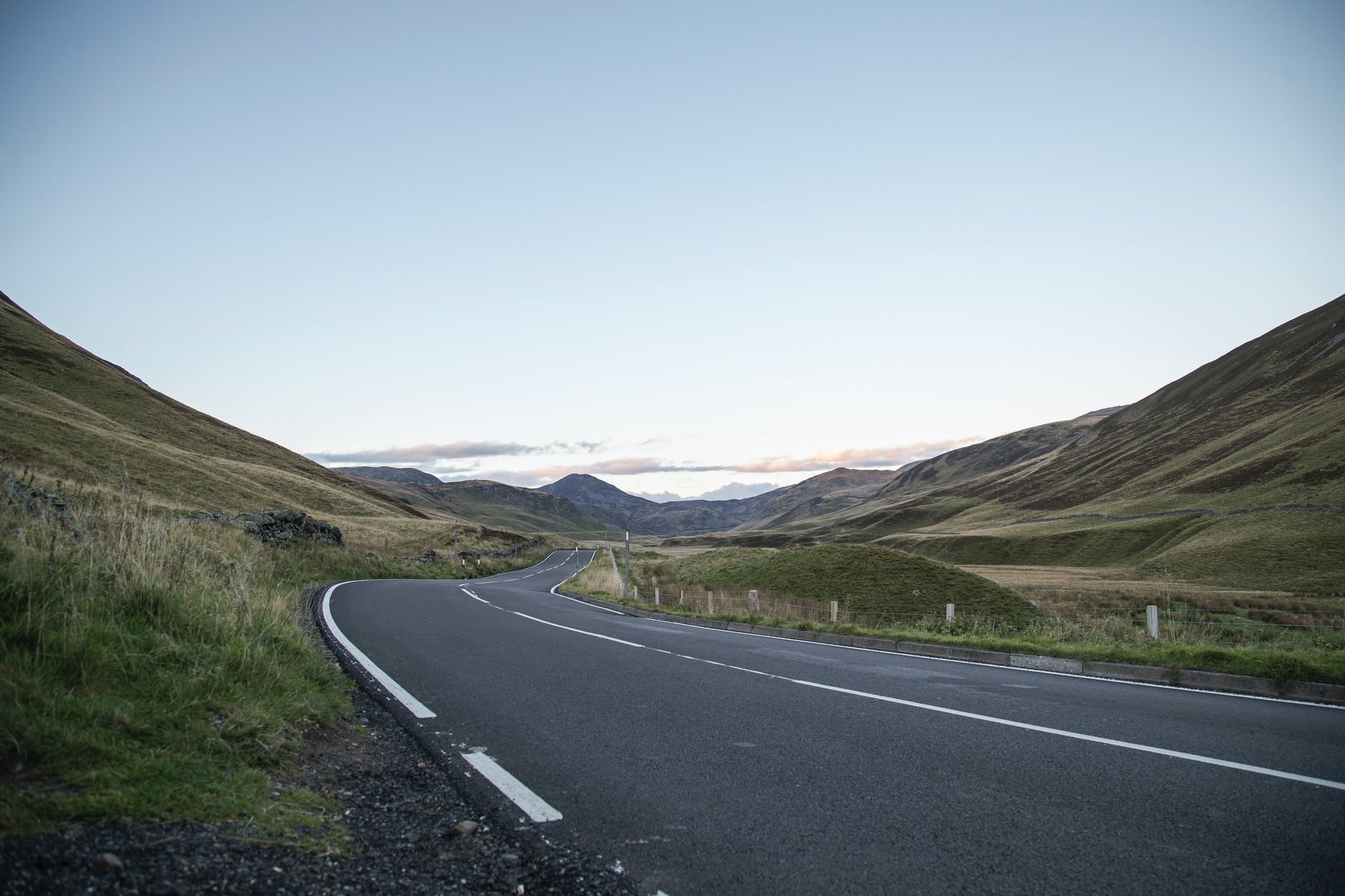 asphalt road through hilly terrain to mountain