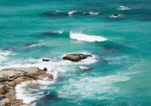 wavy turquoise sea water near stones