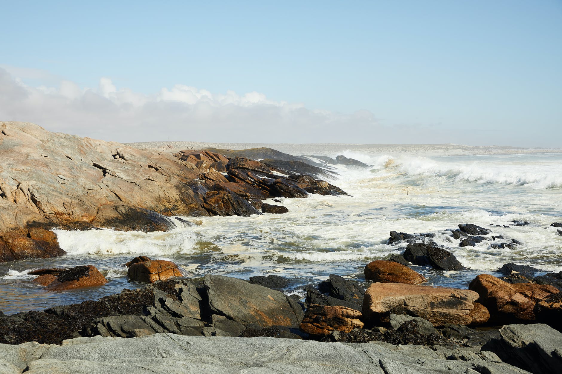 waves of powerful ocean washing rough stones