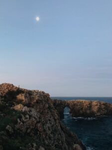 rocky cliff near calm sea