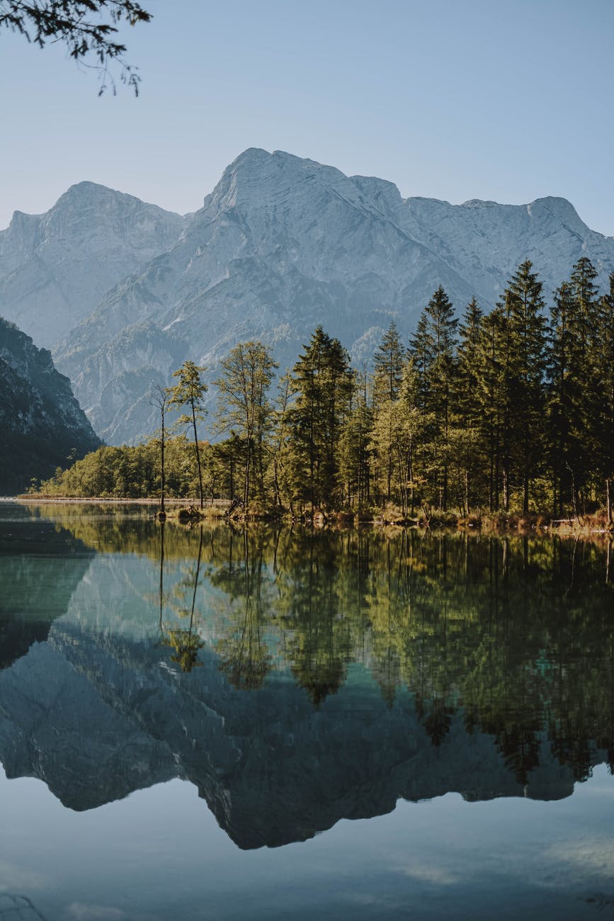 scenic photo of lake across mountain