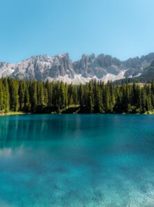 a breathtaking view of the latemar mountain range from lake carezza